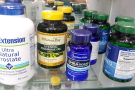 Lực lượng chức năng kiểm tra thu giữ thực phẩm chức năng giả tại số 9 Hoàng Cầu (Hà Nội). (Ảnh: Đỗ Phương Anh/TTXVN)