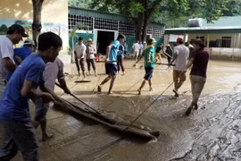 Giáo viên và phụ huynh học sinh tổng dọn vệ sinh tại trường Tiểu học thị trấn Mường Xén, huyện Kỳ Sơn, tỉnh Nghệ An. (Ảnh: Tá Chuyên/TTXVN)