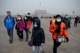 Người dân Trung Quốc đeo khẩu trang để tránh ô nhiễm không khí. (Ảnh: AFP/TTXVN)