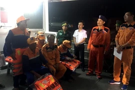 Lãnh đạo Trung tâm Phối hợp tìm kiếm cứu nạn hàng hải Việt Nam thăm hỏi, động viên các ngư dân bị nạn sau khi lên bờ an toàn. (Ảnh: Tá Chuyên/TTXVN)