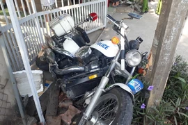 Xe môtô của cảnh sát giao thông bị đâm văng vào vỉa hè. (Ảnh: Nguyễn Văn Việt/TTXVN)