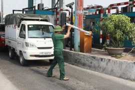 Tài xế tự nhấc barie để đi tại Trạm thu phí BOT cầu Tân Đệ. (Ảnh: Thế Duyệt/TTXVN)