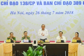 Phó Thủ tướng Thường trực Chính phủ Trương Hòa Bình (giữa), Trưởng Ban Chỉ đạo 138/CP, Trưởng BCĐ 389 chủ trì hội nghị. (Ảnh: Doãn Tấn/TTXVN)