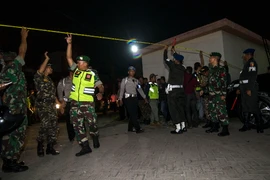 Cảnh sát và binh sỹ Indonesia làm nhiệm cụ tại hiện trường vụ nổ bom ở Đông Java tối 13/5. (Nguồn: AFP/TTXVN)