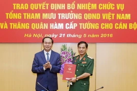 Chủ tịch nước Trần Đại Quang trao Quyết định bổ nhiệm cho Trung tướng Phan Văn Giang. (Ảnh: Nhan Sáng/TTXVN)