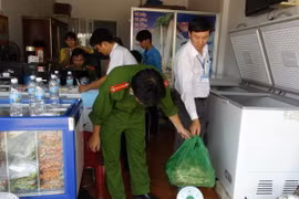 Công an Bình Phước kiểm tra thực phẩm bẩn tại cơ sở Tuyết Ánh, nơi cung cấp thực phẩm trong các bữa ăn cho công nhân của công ty. (Ảnh: Đậu Tất Thành/TTXVN)