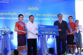 Đại diện Ngân hàng Sacombank Lào trao tượng trưng số tiền 50 triệu kip (tương đương khoảng 6.000 USD) cho đại diện tỉnh Savannakhet để đóng góp vào Quỹ ủng hộ thiên tai tỉnh Savannakhet. (Ảnh: Phạm Kiên/TTXVN)