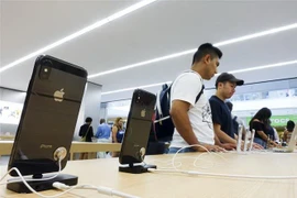 Khách hàng tìm hiểu sản phẩm của Apple tại một gian hàng ở New York, Mỹ. (Nguồn: THX/ TTXVN)