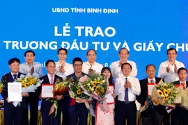 Thủ tướng Nguyễn Xuân Phúc chứng kiến Lễ trao Quyết định chấp thuận chủ trương đầu tư và Giấy chứng nhận đầu tư cho các doanh nghiệp. (Ảnh: Thống Nhất/TTXVN)