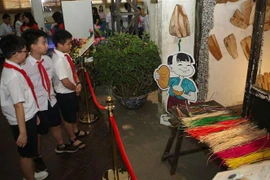 Học sinh tham quan không gian trưng bày ''Tết Đoan Ngọ xưa và nay.'' (Ảnh: Thanh Tùng/TTXVN)
