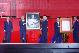 Chủ tịch Quốc hội Vương Đình Huệ trao Nghị quyết của Ủy ban Thường vụ Quốc hội và tặng ảnh Bác Hồ cho đảng bộ, chính quyền và nhân dân thành phố Phổ Yên. (Ảnh: Doãn Tấn/TTXVN)