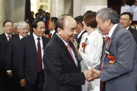 Chủ tịch nước Nguyễn Xuân Phúc dự Lễ tôn vinh và trao danh hiệu Nông dân Việt Nam xuất sắc năm 2022. (Ảnh: Thống Nhất/TTXVN)