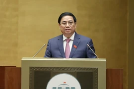 Thủ tướng Phạm Minh Chính trình bày Báo cáo kết quả thực hiện kế hoạch phát triển kinh tế-xã hội năm 2022; dự kiến kế hoạch phát triển kinh tế-xã hội năm 2023. (Ảnh: Dương Giang/TTXVN)