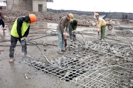 Các lực lượng thi công tiến hành phá dỡ phần vi phạm tại tầng 19 tòa nhà 8B Lê Trực. (Ảnh: Nguyễn Văn Cảnh/TTXVN)