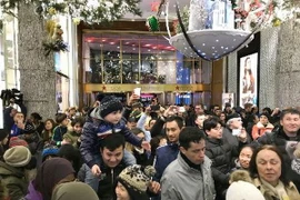 Khách hàng xếp hàng chờ mua sắm bên ngoài cửa hiệu Macys tại New York, Mỹ ngày 23/11. (Ảnh: Kyodo/TTXVN)