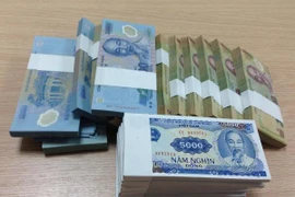 Tiếp tục không in tiển mệnh giá nhỏ dịp Tết. (Ảnh: Vietnam+) 
