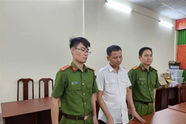 Cơ quan Điều tra bắt giam Lê Văn Ngọc. (Ảnh: TTXVN phát)