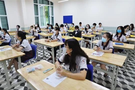 Thí sinh tại điểm Trường Trung học phổ thông Lê Quý Đôn (Quận 3,Tp Hồ Chí Minh) trong phòng thi. (Ảnh: Hồng Giang/TTXVN)