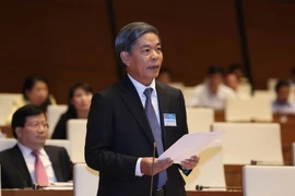 Bộ trưởng Bộ Tài Nguyên và Môi trường Nguyễn Minh Quang trả lời chất vấn. (Ảnh: Phương Hoa/TTXVN)
