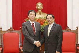 Trưởng Ban Tổ chức Trung ương Phạm Minh Chính tiếp ông Tana CaIu, Phó Trưởng Ban Bí thư Trung ương Đảng Cộng sản Nhật Bản. (Ảnh: Phương Hoa/TTXVN)