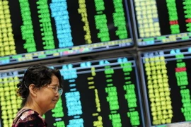 Bảng tỷ giá chứng khoán tại sàn giao dịch ở Cửu Giang, tỉnh Giang Tây, Trung Quốc. (Nguồn: THX/TTXVN)