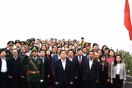 Trưởng Ban Tuyên giáo Trung ương Nguyễn Trọng Nghĩa và các đại biểu thực hiện nghi thức chào cờ tại Cột cờ Quốc gia Lũng Cú. (Ảnh: Minh Tâm/TTXVN)