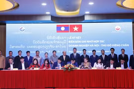 Ký biên bản ghi nhớ hợp tác giữa các doanh nghiệp Hà Nội và Vientiane tại Hội nghị. (Ảnh: Phạm Kiên/TTXVN)
