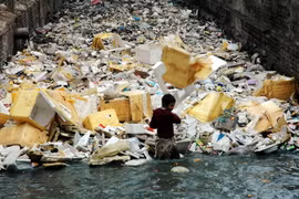  Một em bé Pakistan trong kênh mương bẩn ở ngoại ô Peshawar, phía tây bắc Pakistan. (Nguồn: THX/TTXVN)