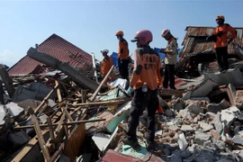 Lực lượng cứu hộ tìm kiếm nạn nhân dưới đống đổ nát sau thảm họa động đất và sóng thần ở Palu, tỉnh Trung Sulawesi, Indonesia ngày 3/10/2018. (Ảnh: THX/TTXVN)