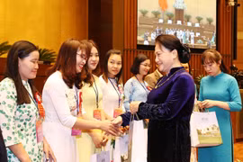 Chủ tịch Quốc hội Nguyễn Thị Kim Ngân tặng quà các giáo viên, nhà quản lý giáo dục tiêu biểu tại buổi gặp mặt. (Ảnh: Trọng Đức/TTXVN)