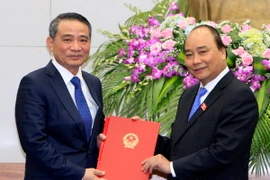 Thủ tướng Nguyễn Xuân Phúc trao quyết định của Chủ tịch nước bổ nhiệm ông Trương Quang Nghĩa giữ chức Bộ trưởng Bộ Giao thông Vận tải. (Ảnh: Thống Nhất/TTXVN)