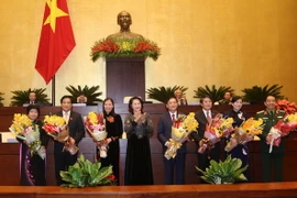 Chủ tịch Quốc hội Nguyễn Thị Kim Ngân tặng hoa chúc mừng bảy thành viên Ủy ban Thường vụ Quốc hội mới được bầu. (Ảnh: Phương Hoa/TTXVN)