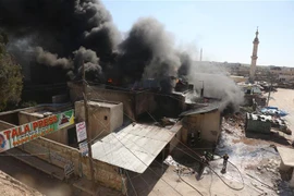 Khói bốc lên sau các cuộc không kích ở thị trấn Khan Sheikhun, tỉnh Idlib, Syria ngày 19/2. (Ảnh: AFP/TTXVN)