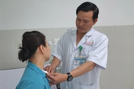 Bác sỹ thăm khám bệnh nhân sau ca phẫu thuật. (Ảnh: TTXVN phát)