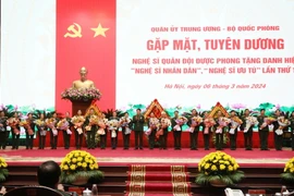 Đại tướng Lương Cường tặng hoa chúc mừng các nghệ sĩ vừa được Nhà nước phong tặng danh hiệu “Nghệ sỹ Nhân dân,” “Nghệ sỹ Ưu tú” lần thứ 10. (Ảnh: Hồng Pha/TTXVN phát)