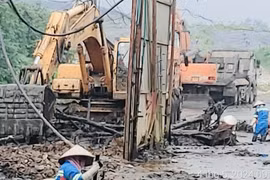 Công ty CP Xây dựng dịch vụ và thương mại 68 huy động nhân lực, máy móc nhanh chóng khắc phục triệt để sự cố sạt lở bao ô lưu chứa bùn tại bãi rác Nam Sơn. (Ảnh: Minh Nghĩa/TTXVN )