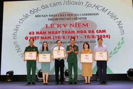 Thiếu tướng Nguyễn Hồng Sơn, Phó Chủ tịch Hội Nạn nhân chất độc da cam/dioxin Việt Nam tri ân các tập thể, cá có nhiều đóng góp tích cực. (Ảnh: Thanh Vũ/TTXVN)