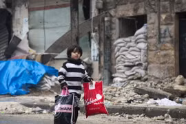 Người dân Syria sơ tán khỏi các khu vực do quân nổi dậy kiểm soát để đến các khu vực đã được quân Chính phủ giải phóng ở Aleppo ngày 13/12. (Ảnh: AFP/TTXVN)