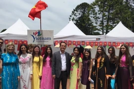 Đại sứ Việt Nam tại Argentina Nguyễn Đình Thao chụp ảnh ảnh các bạn biểu diễn áo dài tại sự kiện. (Ảnh: Phương Lan/Vietnam+)