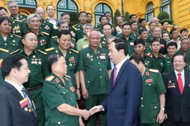 Chủ tịch nước Trần Đại Quang với các đại biểu tại buổi gặp mặt. (Ảnh: Nhan Sáng/TTXVN)