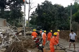 Công nhân Điện lực Yên Bái đang khẩn trương sửa chữa lại hệ thống lưới điện bị hư hỏng sau mưa lũ. (Ảnh: TTXVN phát)