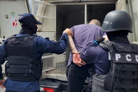 Cảnh sát bắt giữ thành viên băng đảng bị nghi ngờ sản xuất và buôn bán fentanyl. (Ảnh: AFP/TTXVN) 