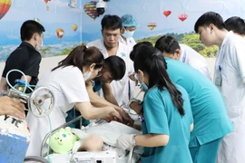 Đội ngũ y bác sỹ Bệnh viện Ung bướu Thành phố Hồ Chí Minh chuẩn bị tiến hành xạ trị áp sát cho bệnh nhi. (Ảnh: TTXVN phát)