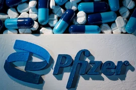 Logo Pfizer được đặt gần các viên thuốc của hãng. (Ảnh: Reuters.)