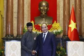 Chủ tịch nước Nguyễn Xuân Phúc tiếp Phó Tổng thống CHLB Nigeria Yemi Osinbajo. (Ảnh: Thống Nhất/TTXVN)