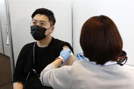 Nhân viên y tế tiêm vaccine phòng COVID-19 cho người dân tại Tokyo, Nhật Bản ngày 25/6/2021. (Ảnh: AFP/TTXVN)