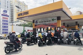 Người dân Thành phố Hồ Chí Minh được hướng dẫn xếp hàng và đảm bảo an ninh trật tự tại cửa hàng xăng, dầu số 4, phường 15, quận Bình Thạnh, Thành phố Hồ Chí Minh. (Ảnh: Mỹ Phương/TTXVN)