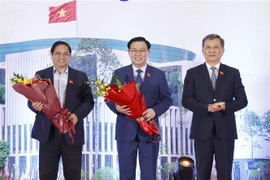 Chủ nhiệm Ủy ban Khoa học Công nghệ Môi trường của Quốc hội Lê Quang Huy đại diện cho các đại biểu Quốc hội khoá XV là nhà khoa học tặng hoa Thủ tướng Phạm Minh Chính và Chủ tịch Quốc hội Vương Đình Huệ. (Ảnh: Doãn Tấn/TTXVN)