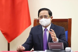 Thủ tướng Phạm Minh Chính điện đàm với Thủ tướng Canada Justin Trudeau. (Ảnh: Dương Giang/TTXVN)