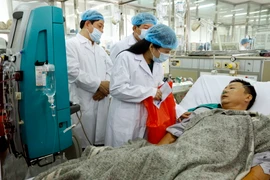 Bộ trưởng Bộ Y tế Nguyễn Thị Kim Tiến đến thăm, tặng quà động viên các bệnh nhân được chuyển về điều trị tại Bệnh viện Bạch Mai. (Ảnh: Dương Ngọc/TTXVN)